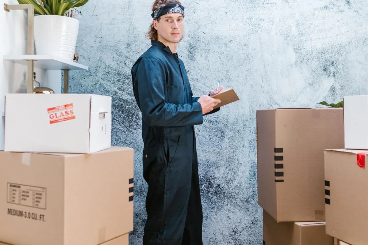 Gati Packers and Movers supervisor checking the room-wise packing list during a move