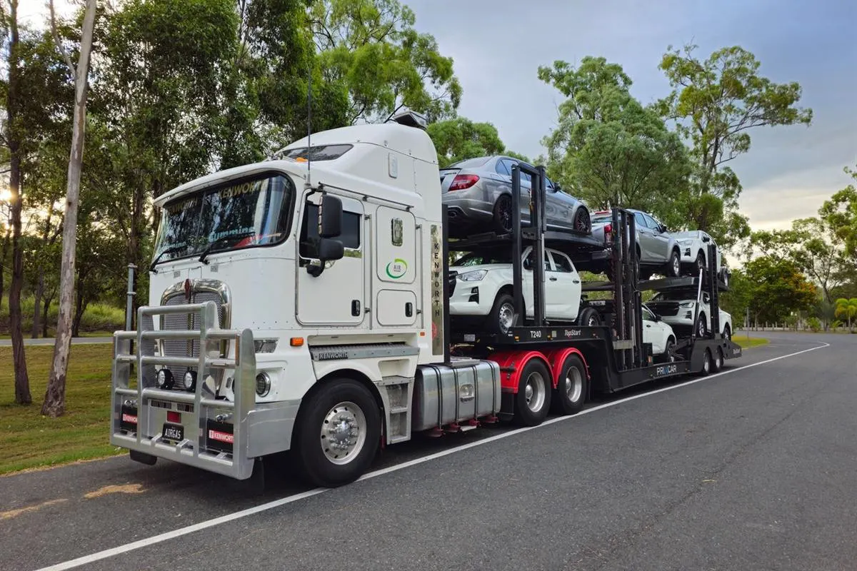 Car secured on an enclosed carrier truck for intercity vehicle transport