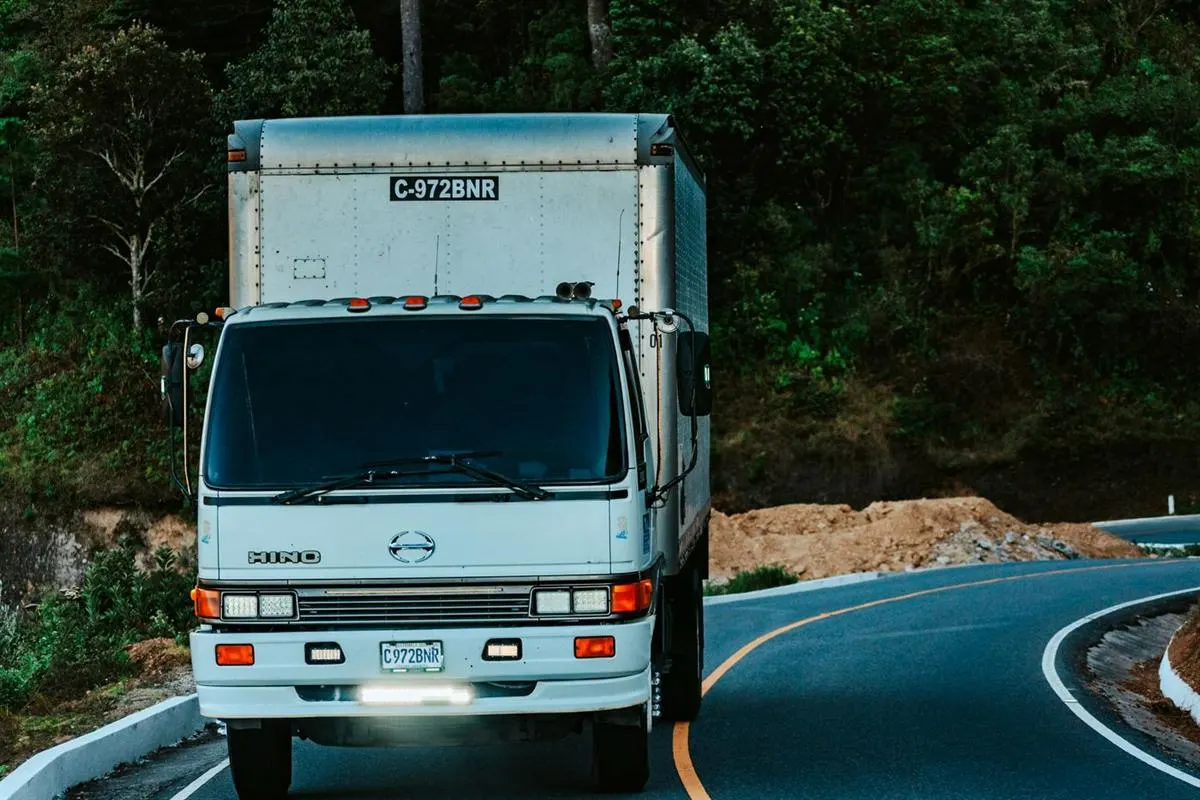 Container truck carrying household goods between cities