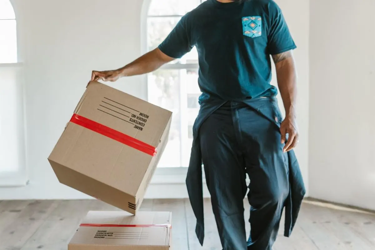Mover carrying sealed cartons out for loading into the vehicle