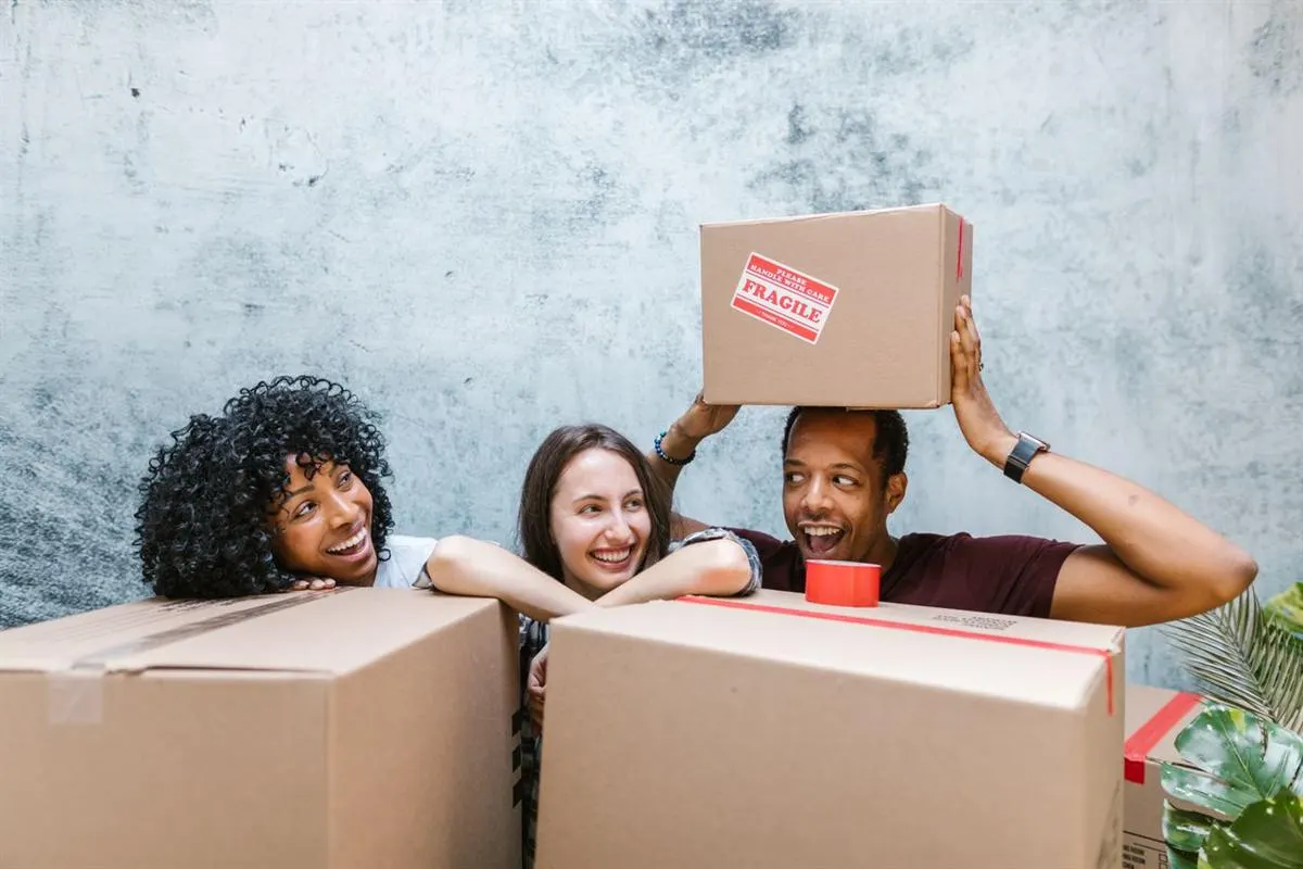 Young flatmates stacking sealed boxes during a small local house shift